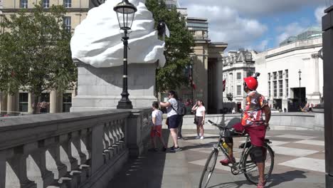 Tourists-look-at-the-modern-art-installation-in-Trafalgar-Square,,-London,-UK