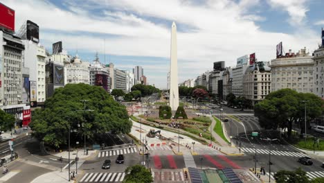 Epic-aerial-shot-of-obelisk-statue-On-Avenida-De-Julio-During-sunny-day-in-Buenos-Aires,Argentinia