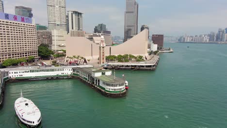 Hong-Kong-culture-centre,-Tsim-Sha-Tsui-pier-and-skyscrapers,-Aerial-view