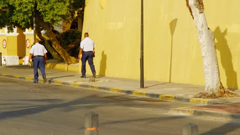 Police-Officers-Walking-And-Roaming-Around-The-City-On-A-Sunny-Day-In-Willemstad,-Curacao