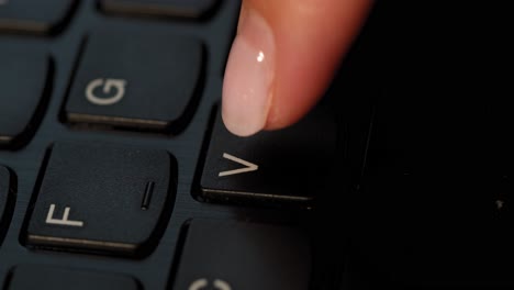Pushing-V-button-on-the-black-keyboard