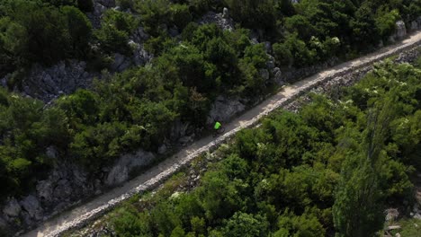 Bacina-Lakes-Bike-Trail---Biker-Cycling-On-The-Trail-In-Dalmatia,-Croatia-On-A-Sunny-Day---aerial