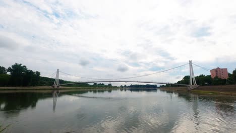 Time-lapse:-desolate-and-empty-walkway-by-Osijek-pedestrian-bridge-above-Drava-river,-covid-19-quarantine,-Croatia,-static