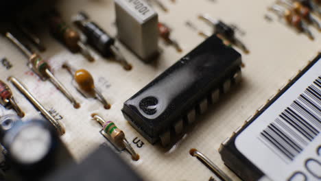 An-IC-integrated-circuit-chip-along-with-many-other-electronic-components-on-a-dusty-old-computer-board