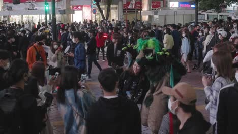 Japanese-Woman-Taking-Picture-With-A-Person-In-Scary-Halloween-Costume-At-Shibuya-Crossing-On-Halloween-Night---hyper-lapse