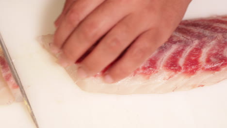 Fresh-Fish-Carefully-Cut-In-Precision-Slices-For-Sashimi---close-up-shot