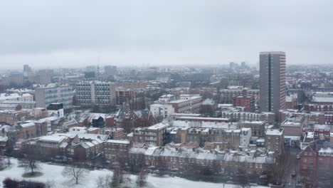 Aerial-drone-shot-over-snow-covered-London-park-East-Bethnal-Green-Whitechapel