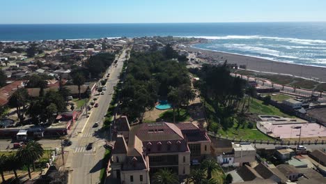Aerial:Parque-Ross,-historic-casino-cultural-center-1904-The-original-park-contains-native-Canary-date-palms-over-a-hundred-years-old-and-many-green-spaces-pichilemu-puntilla-punta-de-lobos-chile
