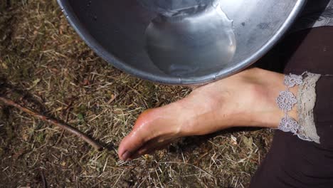Cleaning-dirty-blistered,-callused-feet-at-festival