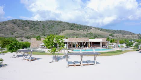 Tourists-relax-in-swimming-pool-of-Puntarena-Bani-beach-resort
