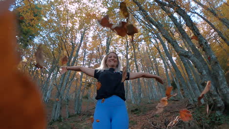 SuperSlowmotion-Zoom-out-of-a-fitness-woman-falling-autumn-leaves-in-the-forest