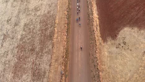 aerial-shot-following-mountain-bikers-on-a-gravel-road