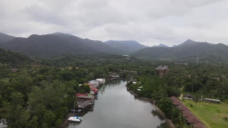 Aerial-view-of-river-and-mountainous-scenery,-backwards-reveal-shot