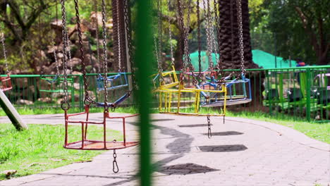 Wide-shot-of-empty-swings-in-an-amusement-park