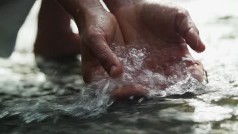 Hands-Scooping-water-in-a-river-at-a-waterfall-on-Vancouver-Island