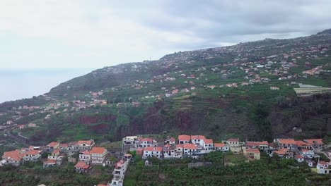 Drone-Flying-Over-The-Lush-Volcanic-Island-Of-Madeira-In-Portugal,-Well-developed-And-Filled-With-Residential-Houses---aerial