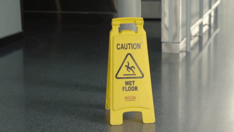 Yellow-caution-wet-floor-sign-in-building