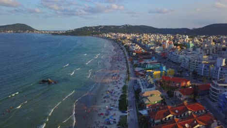 Aerial-dolly-out-shot-revealing-Bombas-beach,-a-popular-destination-in-Brazil