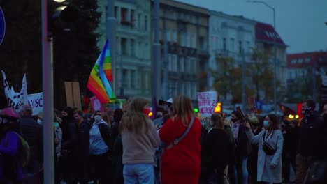 Demonstrators-With-Pace-Rainbow-Flag-And-Banners-In-Szczecin,-Poland---Peace-Movement-Against-Abortion-Ban---medium-shot,-slow-motion
