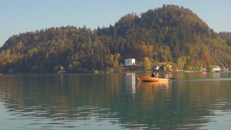 Two-people-rowing-in-the-boat-on-lake-Bled,-Slovenia