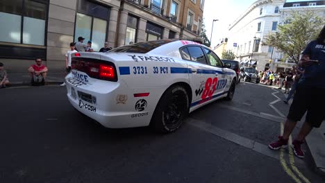 Custom-NYPD-Dodge-charger-police-cruiser-driving-at-Gumball-3000-rally-parade-London