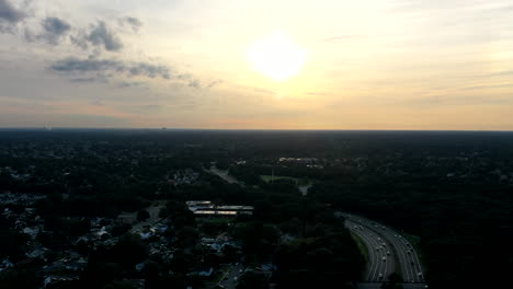 a-high-angle-aerial-view-over-a-parkway-in-the-morning-at-sunrise