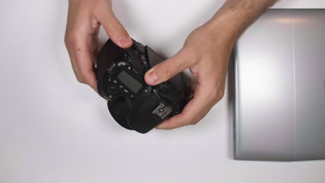 Hand-Removes-Memory-Card-From-Laptop-And-The-Returned-To-DSLR-Camera
