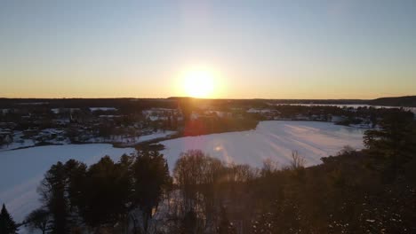 aerial-of-a-Winter-sunset-going-towards-sun-and-city