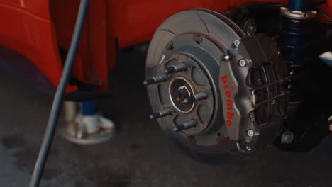 Moving-Shot-of-a-Slotted-Rotor-and-Brembo-Brake-Caliper-on-GT3-Ford-GT