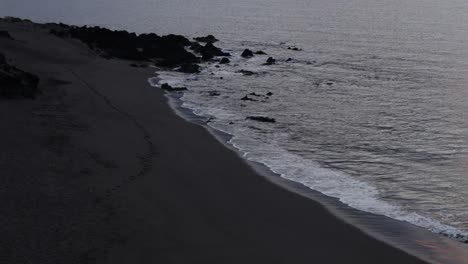 Sandy-beach-with-waves-and-footprints-at-the-evening-time,-Tenerife