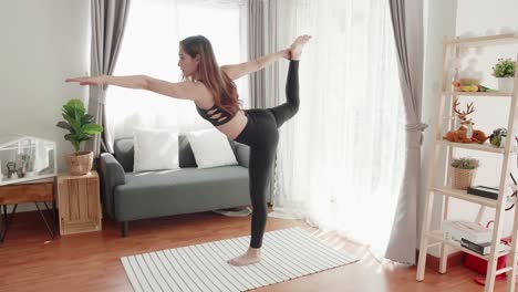 Lovely-women-in-good-shape-with-yoga-exercise-and-stretching-in-the-living-room