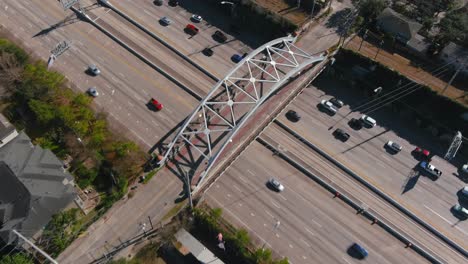 Aerial-of-cars-on-59-South-freeway-in-Houston,-Texas-on-a-bright-sunny-day