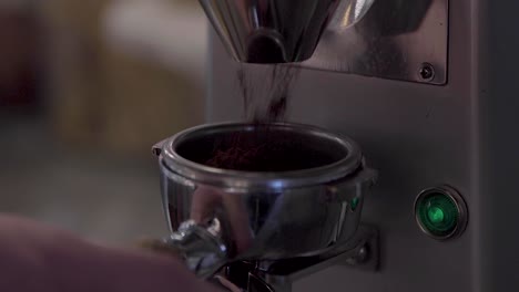 Filling-Portafilter-With-Freshly-Ground-Coffee,-close-up