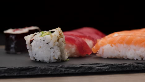 Japanese-Asian-food-sushi-nigiri,-tuna,-hosomaki,-uramaki-assortments-on-a-plate