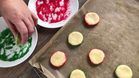making-Christmas-sugar-cookies-rolling-edges-with-red-and-green-sprinkles