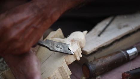 wood-Craft,-Carpenter-is-creating-wooden-statue,-Woodcarving-is-a-traditional-handicraft-in-india,-2