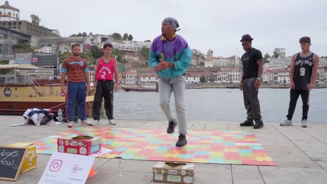Street-dancers-breakdance-for-donations-on-the-streets-of-Porto,-Portugal