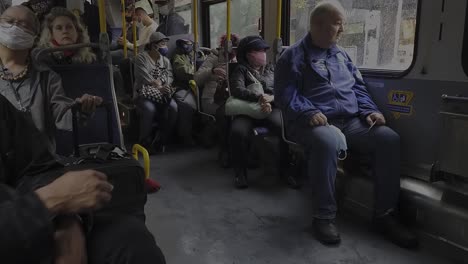 Vancouver-Canada-BC-COIVID-19-statistics-climb-with-an-unenforcement-in-example-of-Passengers-bord-a-bus-wearing-masks-then-get-unmasked-during-the-ride-touching-their-face-seated-close-to-each-other