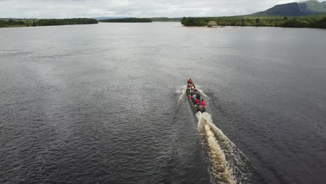 Aerial-shot-of-motorboat-on-the-Carrao-River,-Canaima-National-park,-Venezuela,-high-angle-tracking-shot
