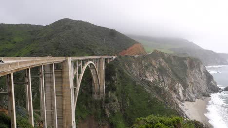 Ultra-slow-motion-shot-of-Bixby-Creek-Bridge-viewed-from-the-side-in-California,-USA