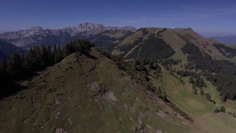 Aerial-Landscape-Flight-Over-The-Mountain-Revealing-a-Village,-Bec-Du-Corbeau,-Switzerland