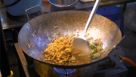Stir-fried-noodles-being-made-in-a-wok-on-the-side-of-the-street