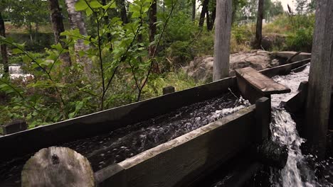 Water-going-through-old-wooden-river-mill-in-slow-motion-bypassed