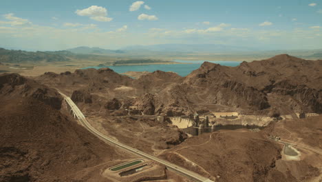 Aerial-wide-shot-of-Hoover-Dam-on-sunny-summer-hot-day,-side-angle