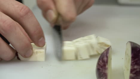 Close-up-of-a-chef-dicing-an-eggplant