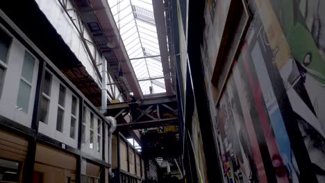 A-pan-revealing-a-big-industrial-hall-of-the-NDSM-Loods-or-IJ-hallen,-a-cultural-hotspot-and-tourist-attraction-in-Amsterdam