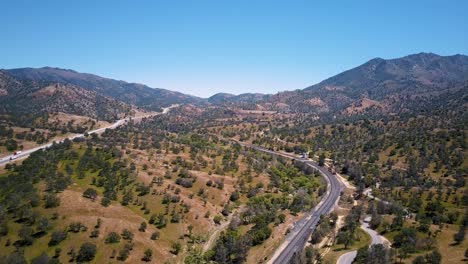 Aerial-Pan-over-Tehachapi-Pass-railway-and-cars-on-highway-in-California