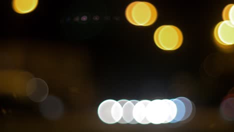 Moving-bokeh-car-traffic-lights-in-city-during-the-night