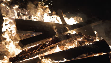 4K-Video-of-wood-being-added-to-a-Bonfire