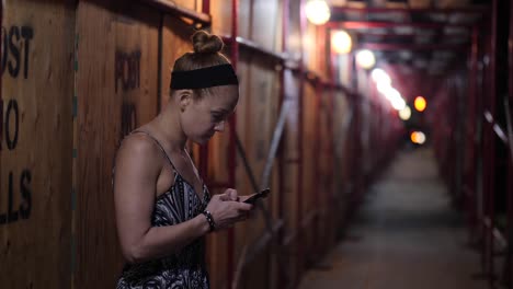 Redhead-Woman-worried-with-her-Smartphone-at-night-in-Slow-motion